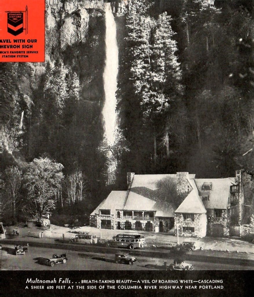 A black and white photo from 1936 of Multnomah Falls in Oregon State. You also see a hotel in the foreground of the photo. The falls is in the back of the photo.