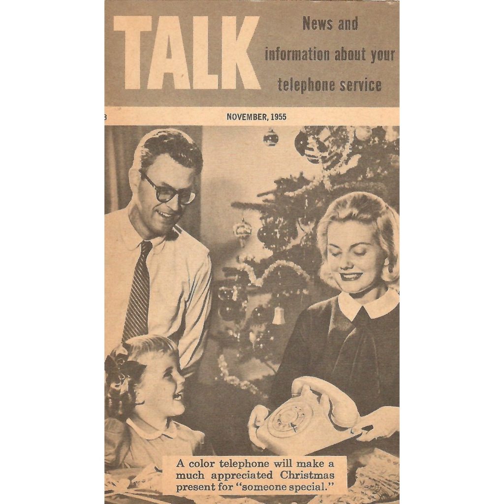 Cover of the November 1955 issue of the newsletter “Talk.” It shows a family in front of a Christmas tree commenting on a color Rotary Telephone.