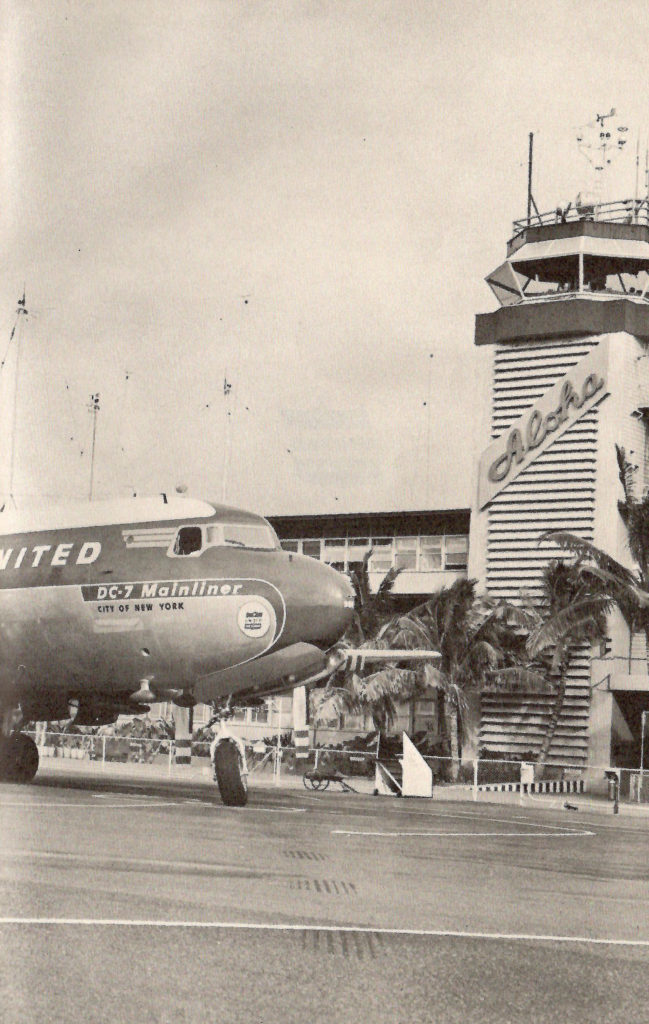 A United DC 7 parked in front of a tower in Hawaii. A sign on the tower says Aloha. Part of a booklet published by United Airlines in the late 1950s going behind the scenes of a typical airport.